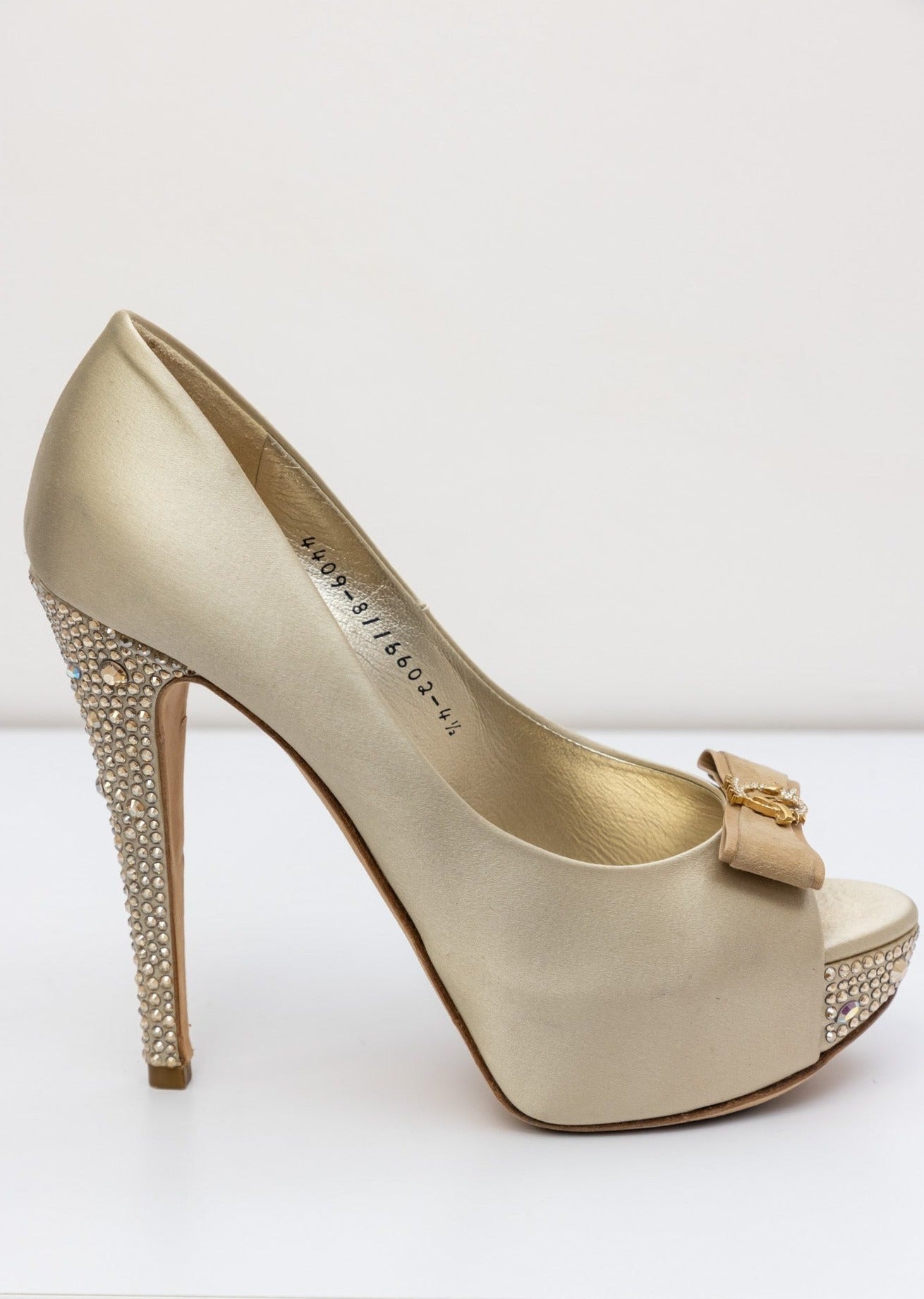 Gina Golden satin pumps with embellished crystal heel and platform, front bow with gold logo