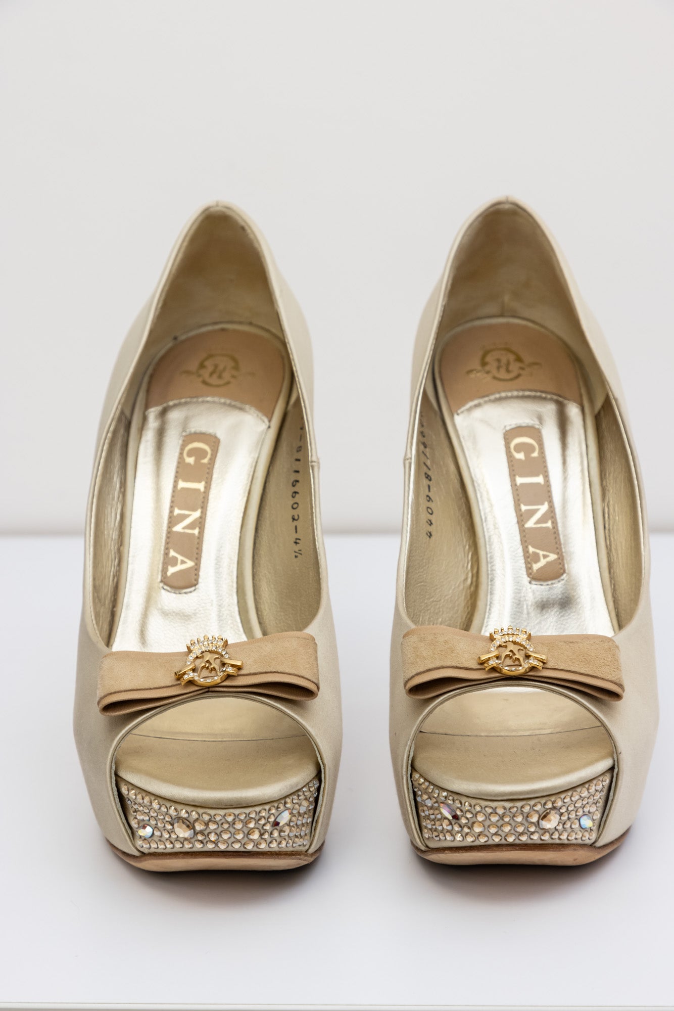 Gina Golden satin pumps with embellished crystal heel and platform, front bow with gold logo
