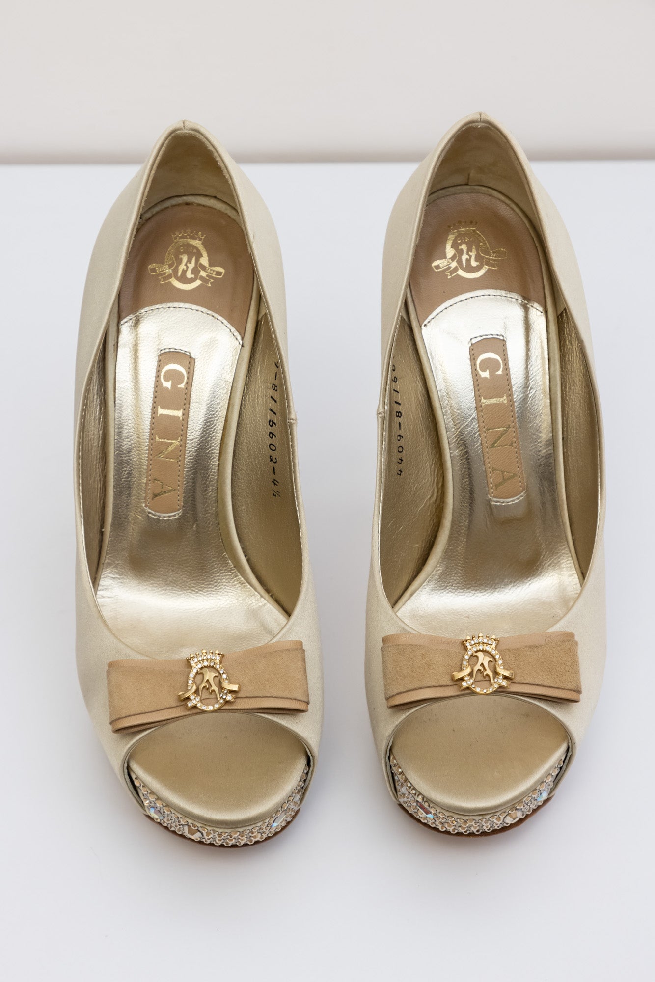 Gina Golden satin pumps with embellished crystal heel and platform, front bow with gold logo