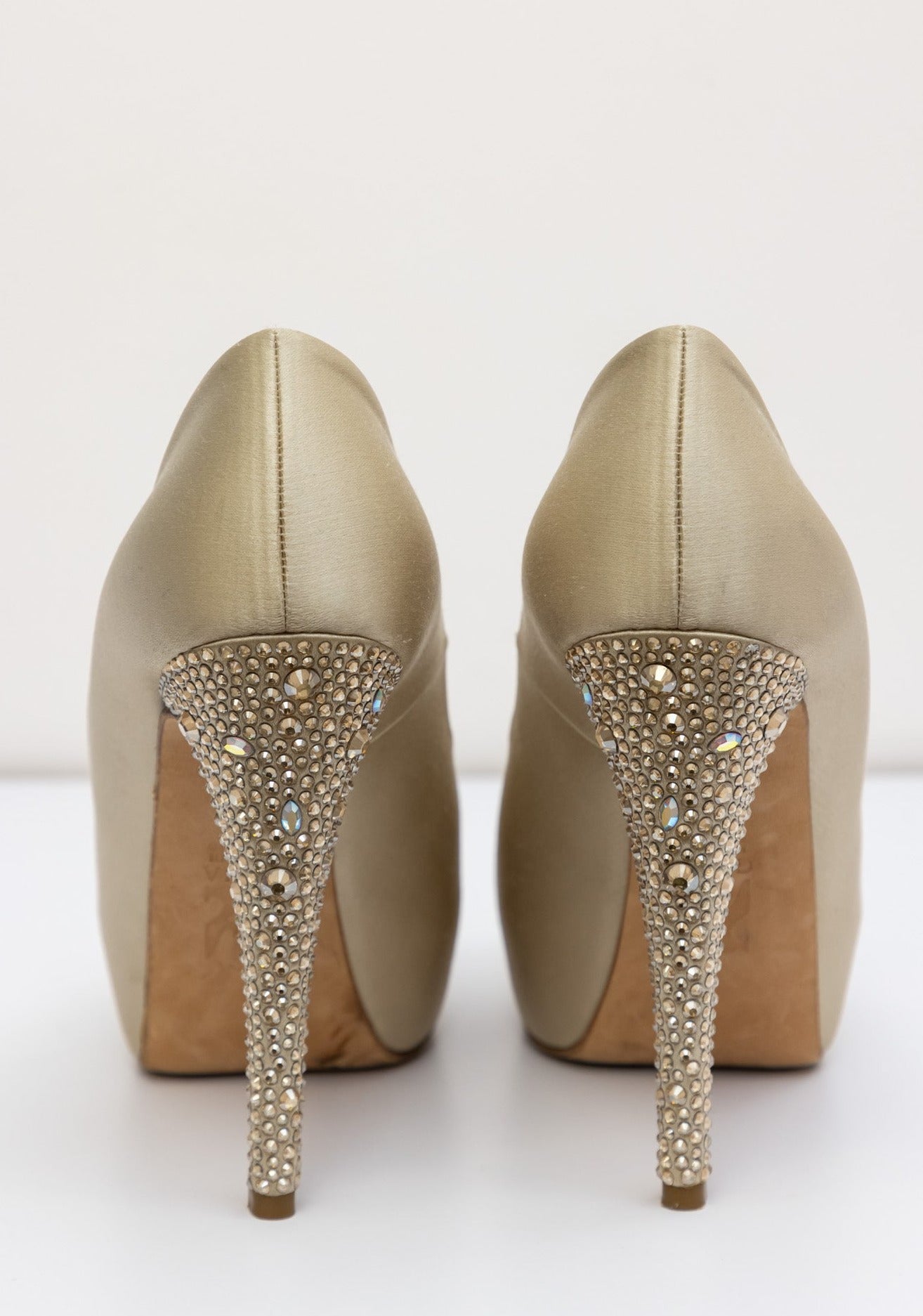 Gina Golden satin pumps with embellished crystal heel and platform, front bow with gold logo