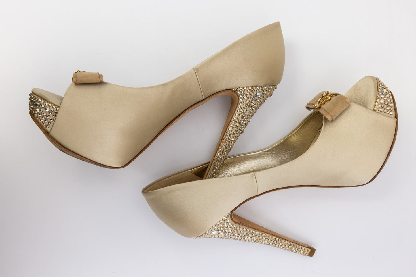 Gina Golden satin pumps with embellished crystal heel and platform, front bow with gold logo