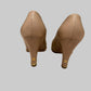 Chanel CC logo gold heel detail on beige platform pumps