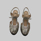A pair of Fendi metallic silver slingback high-heeled sandals with cutout detailing and ankle straps.
