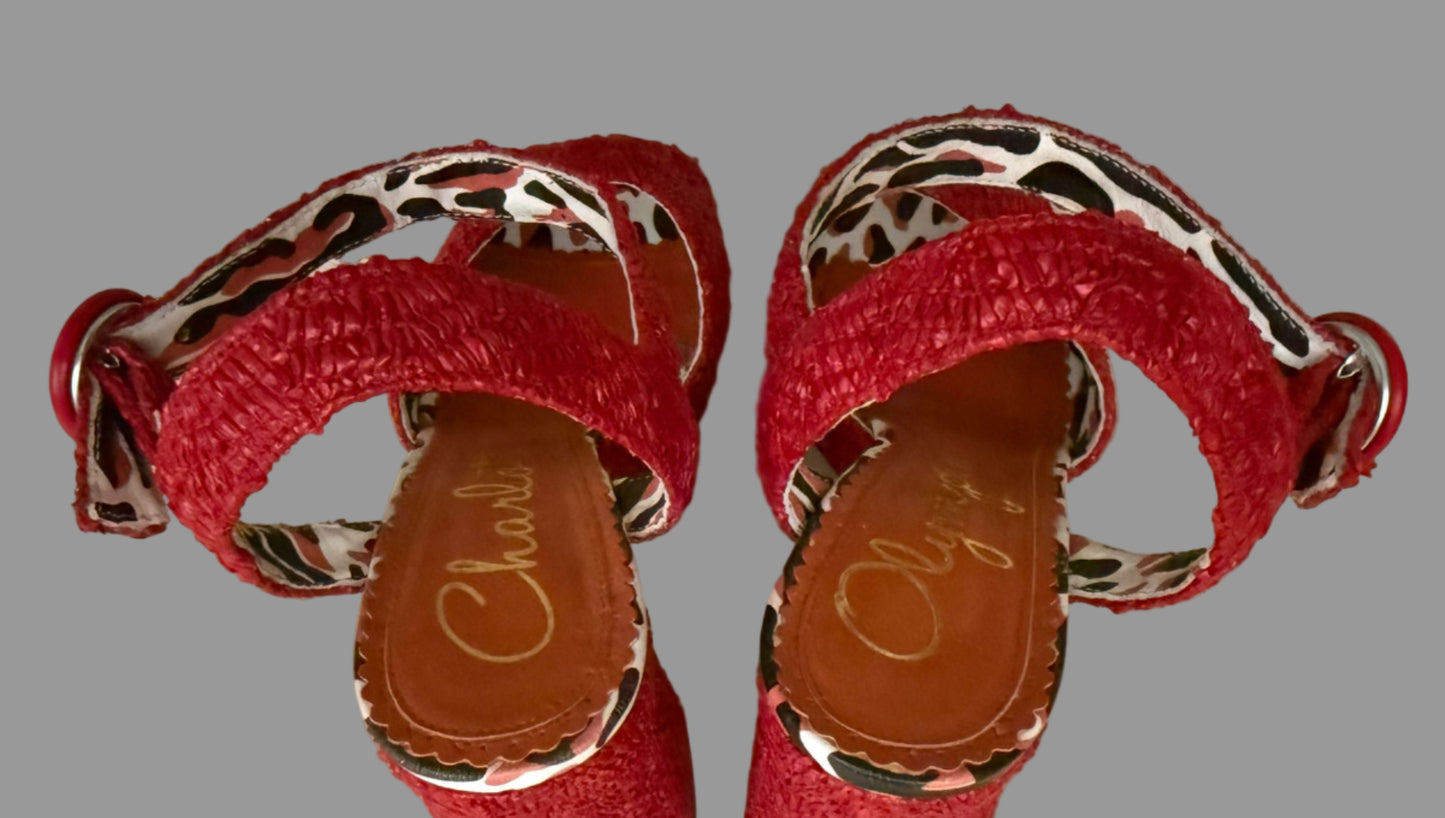 Red sandals with leopard print straps on a light background