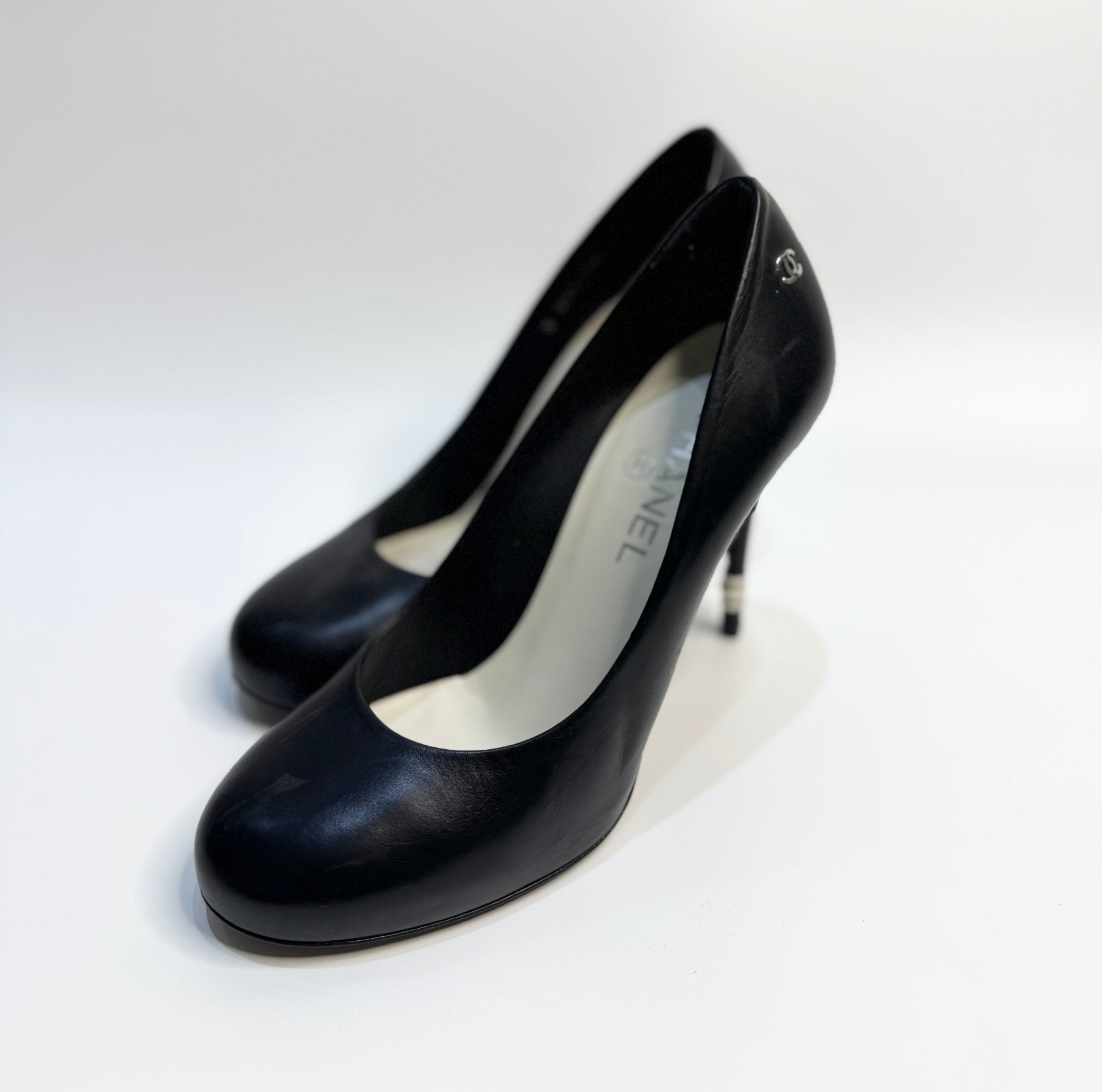 A pair of CHANEL black leather pumps