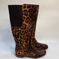 Side angle of the leopard print boots, highlighting the soft calf hair texture and knee-high design.