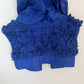 Back view of the vibrant blue MONCLER silk vest jacket featuring intricate flower detailing and a hood. The back showcases a sleek and elegant design with subtle texture from the detailed flowers. The hood is neatly integrated into the neckline, adding both functionality and style.